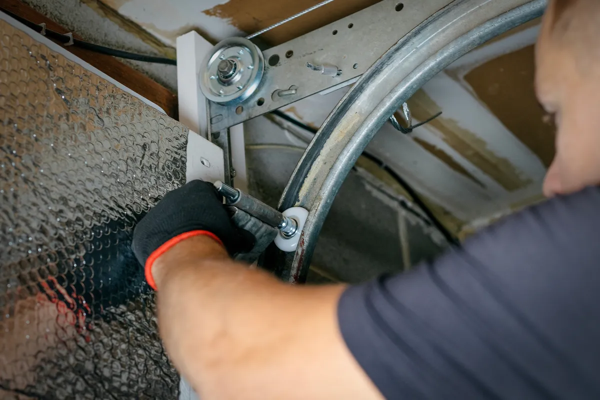 Garage door repair viewed from inside a garage